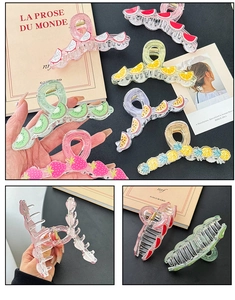 Detailed view of various fruit print hair claw clips with glittery acrylic finish