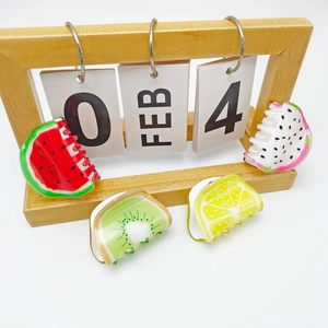 Set of four colorful fruit hair clips featuring watermelon kiwi lemon dragon fruit shapes