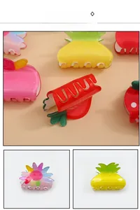 Gros plan de pinces à cheveux en acrylique pailleté aux motifs d'ananas et de fraises