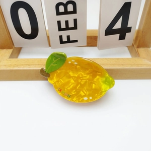 Cute lemon hair claw clip in yellow acetate with colorful LEMON text decoration