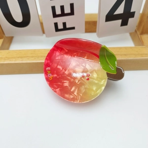 Detailed view of a peach-shaped hair claw clip with marble texture and PEACH lettering