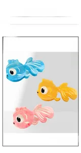 Detailed view of large goldfish-shaped acetate hair clips in blue, yellow and pink colors