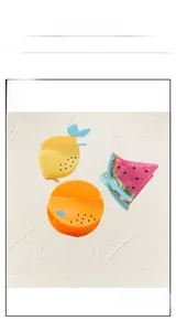 Macro shot of fruit-shaped acetate hair claws including lemon, watermelon, and orange