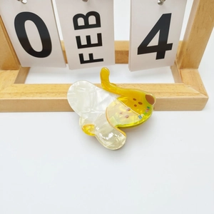 Detail of banana hair claw made of pearlescent acetate with realistic fruit design