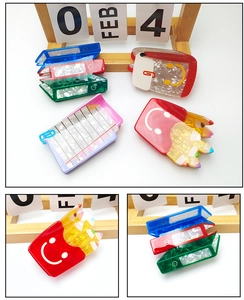 Detail view of colorful acetate hair claws in stationery shapes like files and notebooks