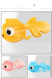 Detailed view of three colorful goldfish hair claws made from premium acetate material