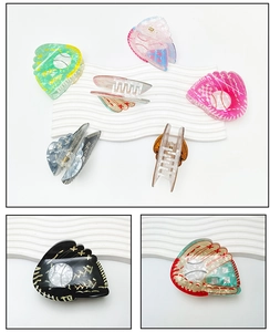 Detailed macro view of baseball glove claw clips made of premium acetate with metal springs