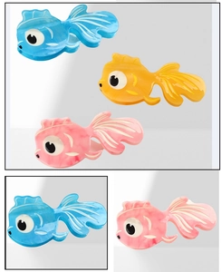 Detailed macro view of goldfish hair claws in blue, orange, and pink acetate marble texture