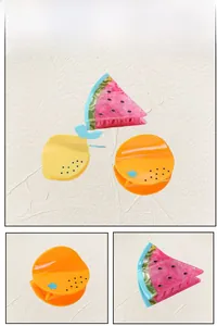 Detailed close-up showing fruit-shaped acetate hair claws including watermelon and orange