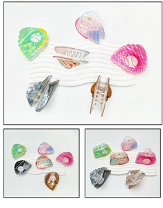 Detail view of multi-color baseball glove claw clips in green pink blue and brown
