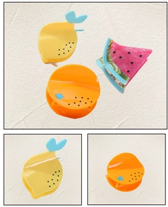 Detailed view of vibrant lemon, orange and watermelon shaped acetate hair claw clips