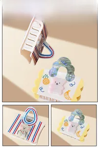 Detailed views of acetate handbag-shaped hair claws with cute cartoon dog and bear patterns