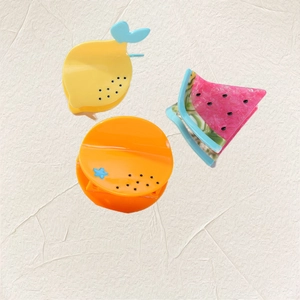 Three-piece fruit shaped hair clips set including lemon, orange, and watermelon designs