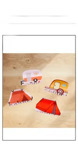 Detailed macro view of four acrylic camping-themed hair claws featuring RV and tent designs