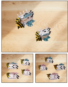 Close-up of cute bee-shaped hair claws made of acetate with colorful marble texture