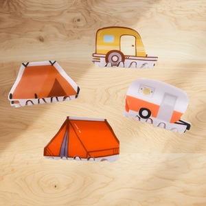 Cute cartoon camping hair claws featuring creative tent and RV designs on wood background