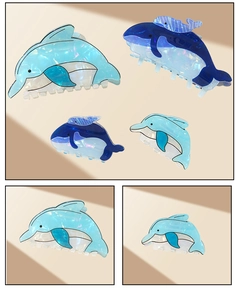 Detailed view of dolphin-shaped hair claws in blue pearl finish for ocean-themed styling