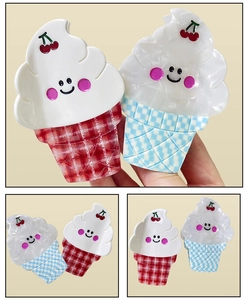 Close-up of cute checkered ice cream hair claws with cream, cherry, and smiley face detail