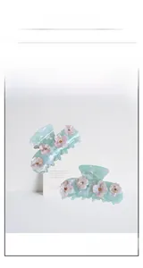 Détail de la pince à cheveux vert menthe marbré avec fleurs 3D roses et perles