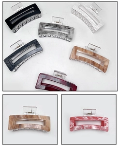 Detail view of large rectangular hair claw clips in various marble and solid patterns