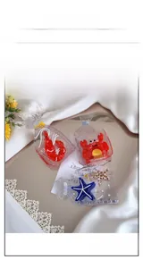 Close-up of creative clear acetate hair claws with miniature 3D seafood snack designs