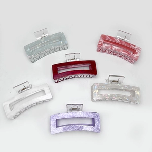 Set of six colorful rectangular hair claw clips with marble texture on white background