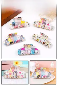 Detail view of large hair claw clips featuring cute cartoon animal resin patterns