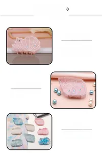 Detail of seashell hair claws with glitter finish and faux blue gemstones
