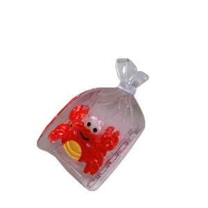Creative transparent acetate hair claw clip with a red crab inside a plastic bag design