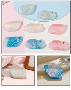 Close-up of ocean-themed resin hair claws with seashell and starfish details