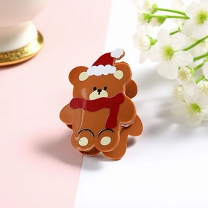 Cute Christmas bear hair claw clip made of brown acrylic with a festive red hat and scarf