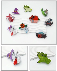 Detail view of Halloween hair clips with glitter finish and marble textures