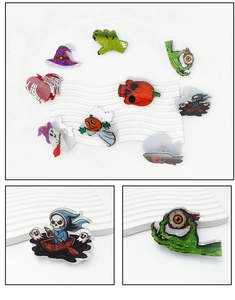Macro detail of acrylic Halloween hair clips featuring ghost, pumpkin and skull designs