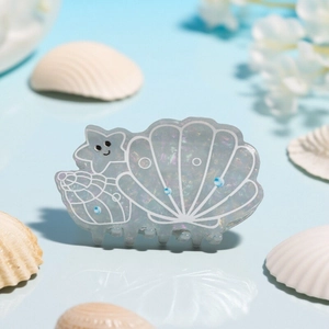 Pearlescent seashell and starfish hair claw clip with ocean theme in translucent grey