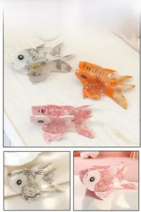 Detail view of goldfish acetate hair claws in white, orange and pink color options