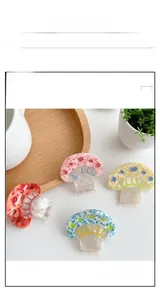 Detailed macro shot of four colorful mushroom hair clips with marble texture
