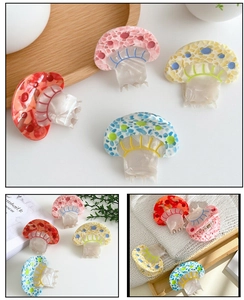 Close-up of colorful mushroom hair claws with marble texture and dotted details