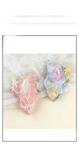 Close-up of shell-shaped cellulose acetate hair claws with marble texture and star detail