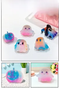 Detail shot of gradient rainbow Halloween ghost and pumpkin hair clips with matte finish