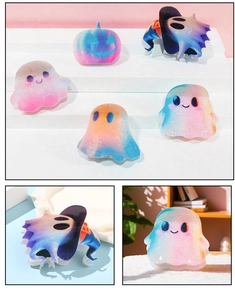 Detailed view of iridescent gradient Halloween ghost and pumpkin hair claws in high-quality resin