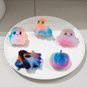 Glittery Halloween ghost and pumpkin hair claw clips in colorful dream gradient finish