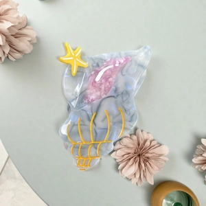 Acetate conch shell hair claw with starfish and marble texture in blue finish