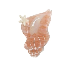 Acetate conch hair claw clip in peach pink marble texture with a small starfish accent
