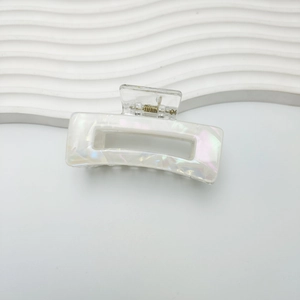 Iridescent white rectangle hair claw clip with pearlescent finish and gold metal spring