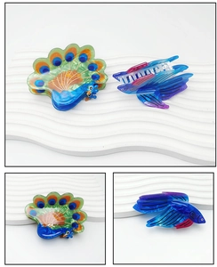 Detailed close-up of peacock and fish shaped acetate hair claws in vibrant colors
