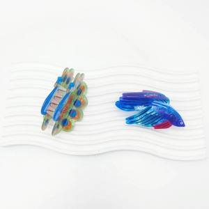 Acrylic peacock and fighting fish hair claws with vibrant gradient colors and creative design