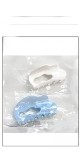 Macro shot of large acetate cloud hair clips in beige and icy blue colors