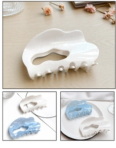 Detail of cloud-shaped hair claw clips with marble texture and heart cutout design
