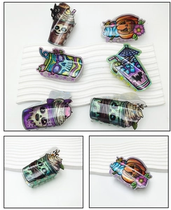 Detailed macro view of creative Halloween acrylic hair claws with spooky drink cup designs