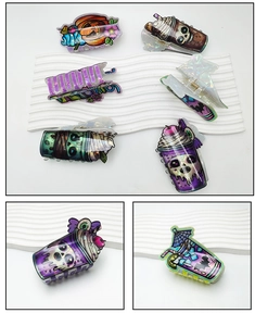 Detailed view of holographic Halloween hair clips with pumpkin and skull cup designs